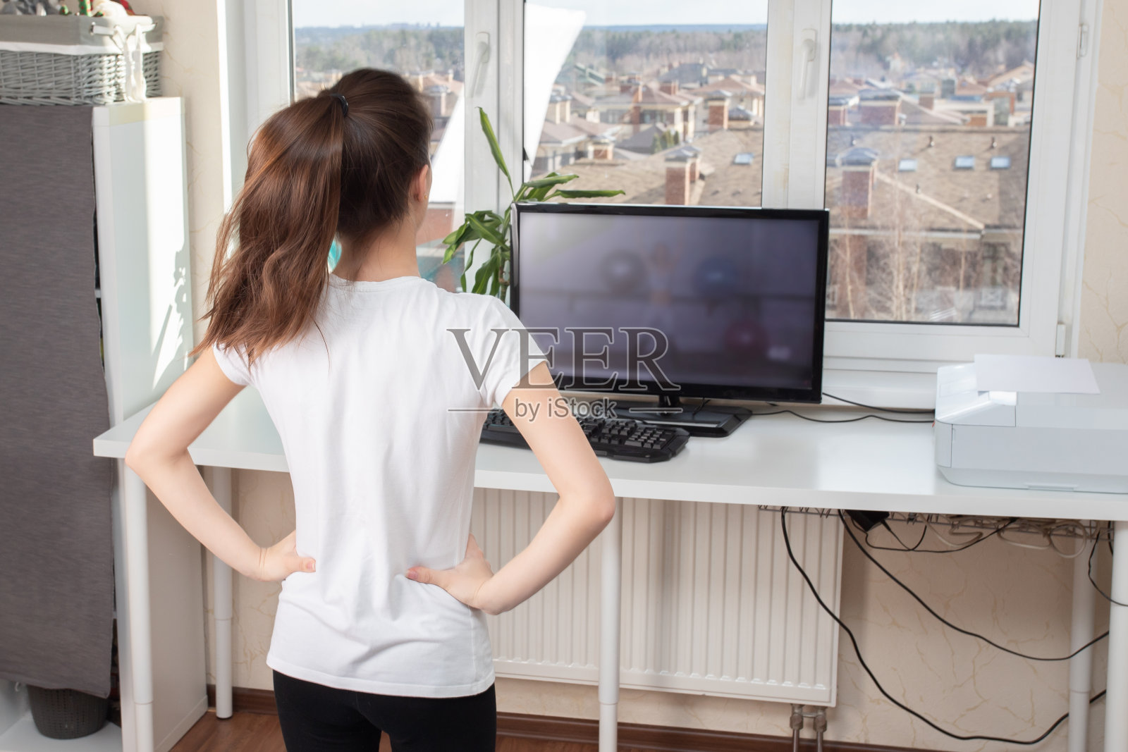 在家美容健康。通过互联网进行体育运动。年轻女子做运动照片摄影图片