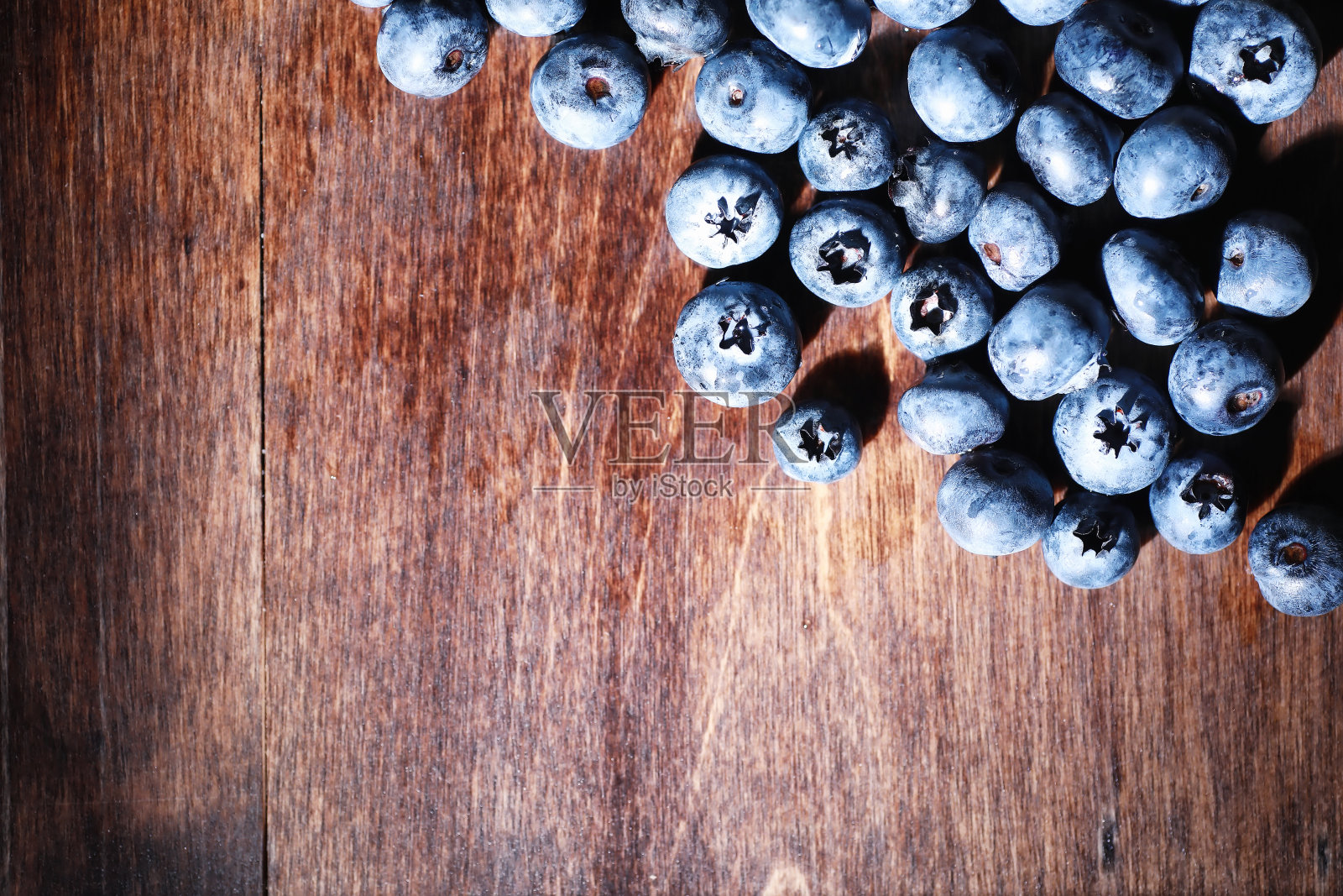 水滴在成熟的甜蓝莓上。新鲜的蓝莓背景与复制空间为您的文本。纯素和素食的概念。蓝莓浆果的宏观质地。照片摄影图片