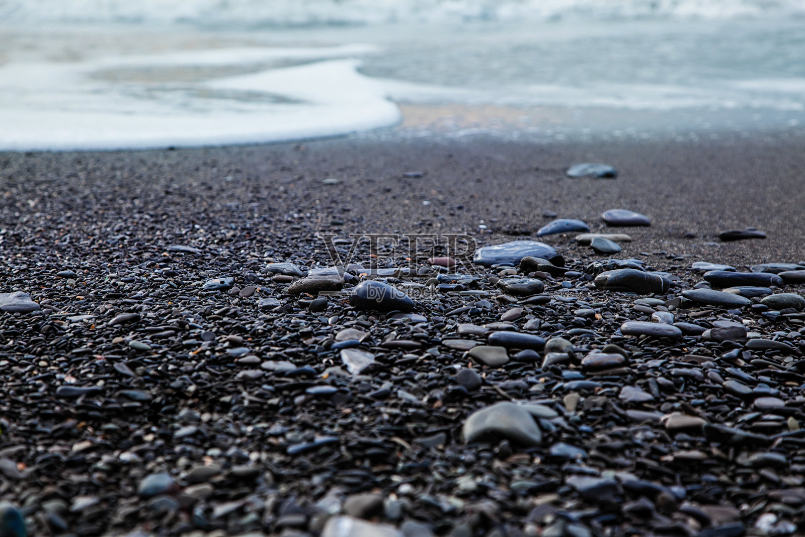 卵石滩,特写。海滨的背景。照片摄影图片