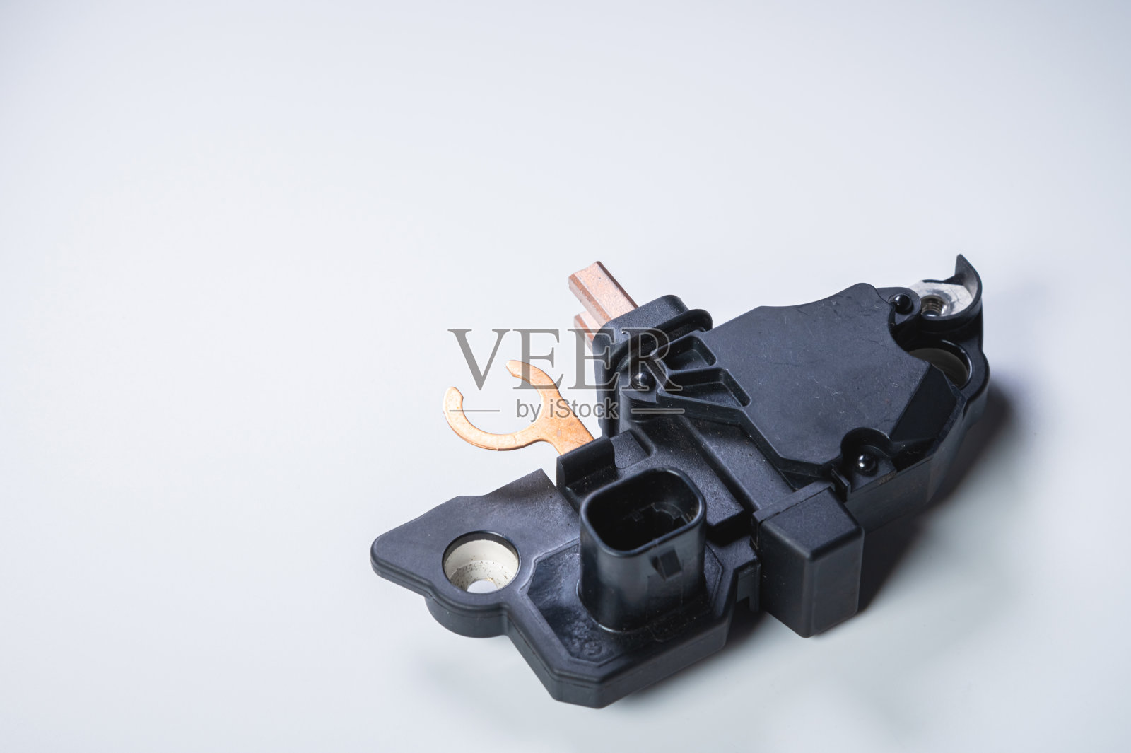 汽车继电器稳压器。灰色背景上的新电动车零配件照片摄影图片