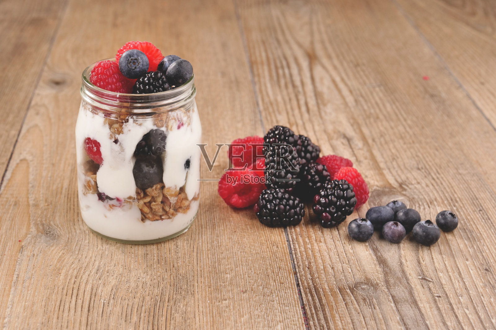 由酸奶,蓝莓,覆盆子,黑莓组成的典型的真正的早餐照片摄影图片