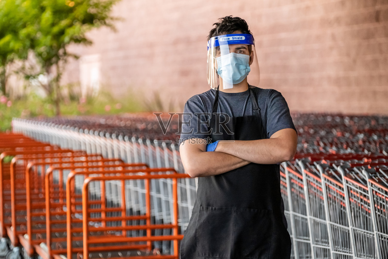 超市员工戴口罩和乳胶手套以防感染照片摄影图片