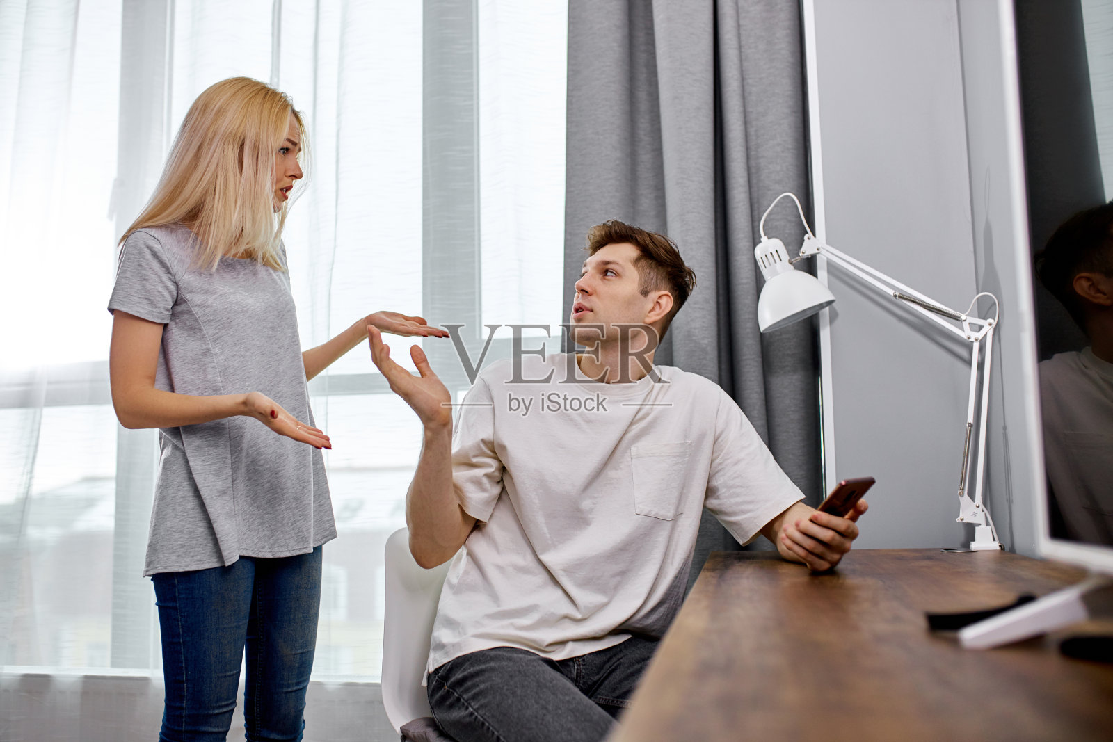 妻子没有足够的关注她的丈夫,他总是坐在电话照片摄影图片