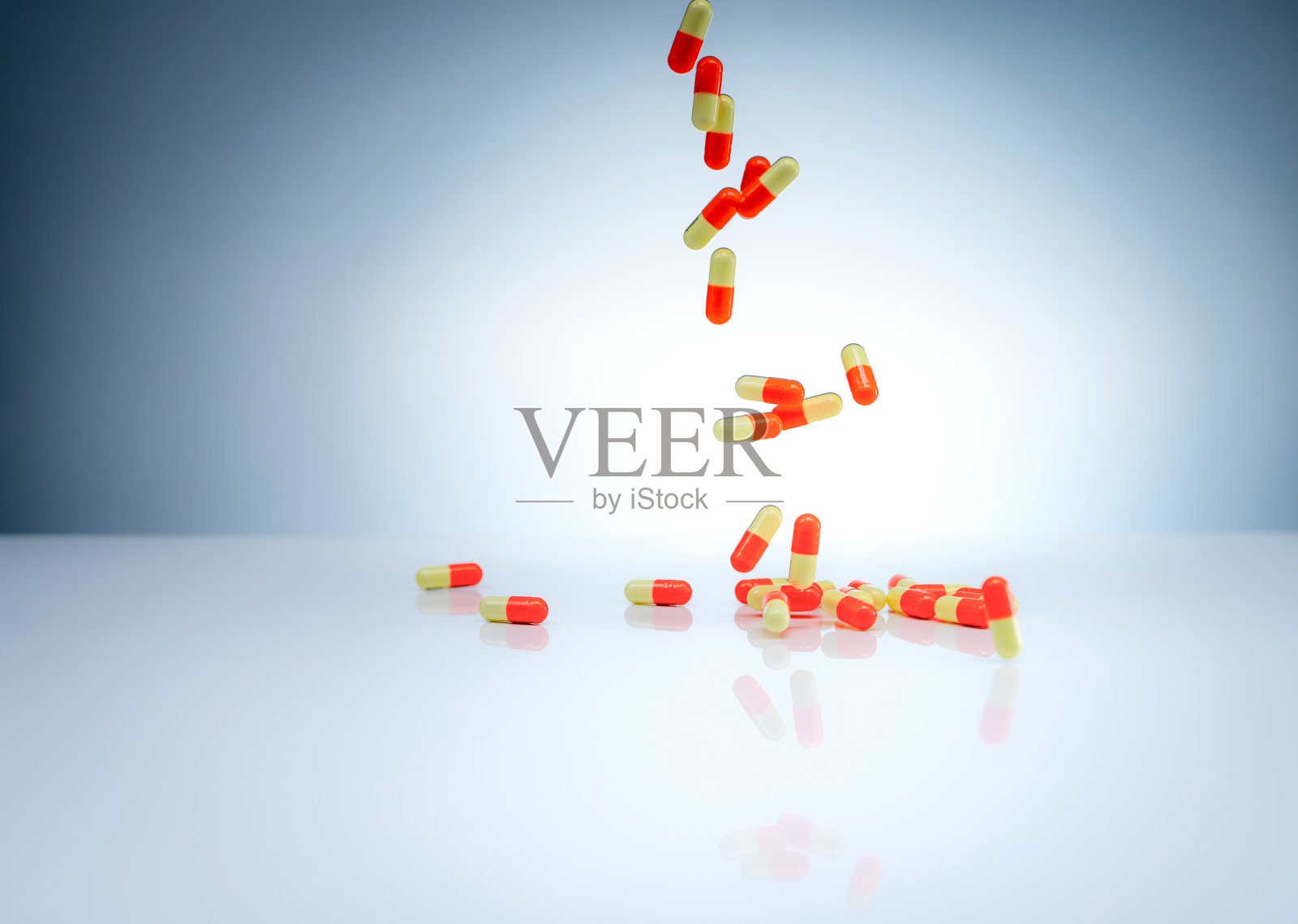 橙黄色的胶囊丸落在白色的桌上。制药行业。药物相互作用、副作用和药物不良反应(ADR)背景。药物滥用的概念。全球医疗保健。照片摄影图片