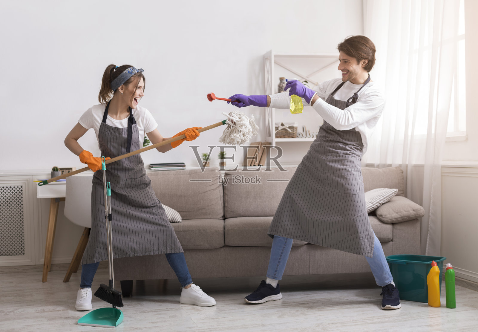 做家务的乐趣。年轻夫妇在家里春季大扫除时在一起嬉戏照片摄影图片