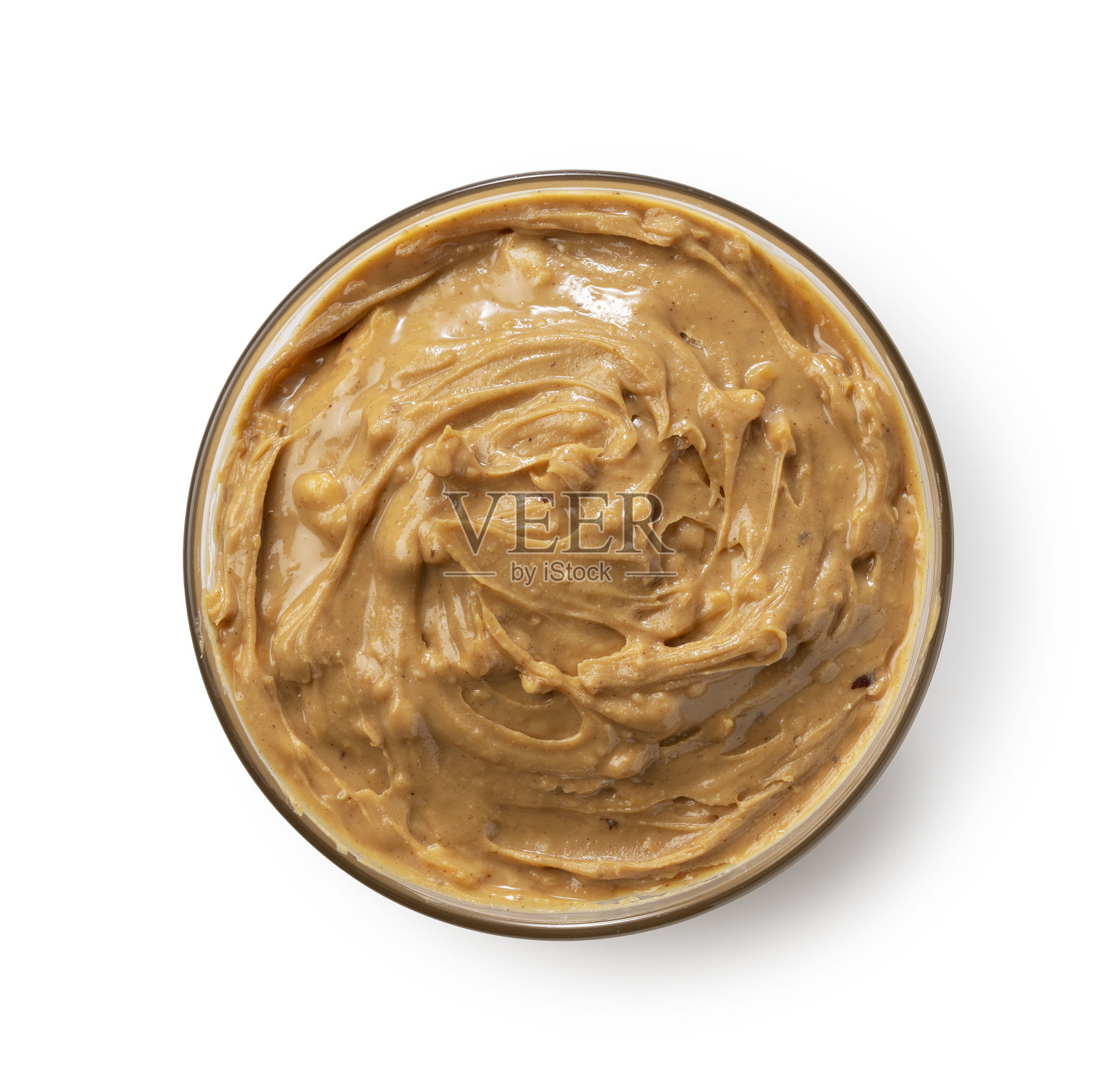 玻璃碗里的花生酱,背景是白色。照片摄影图片