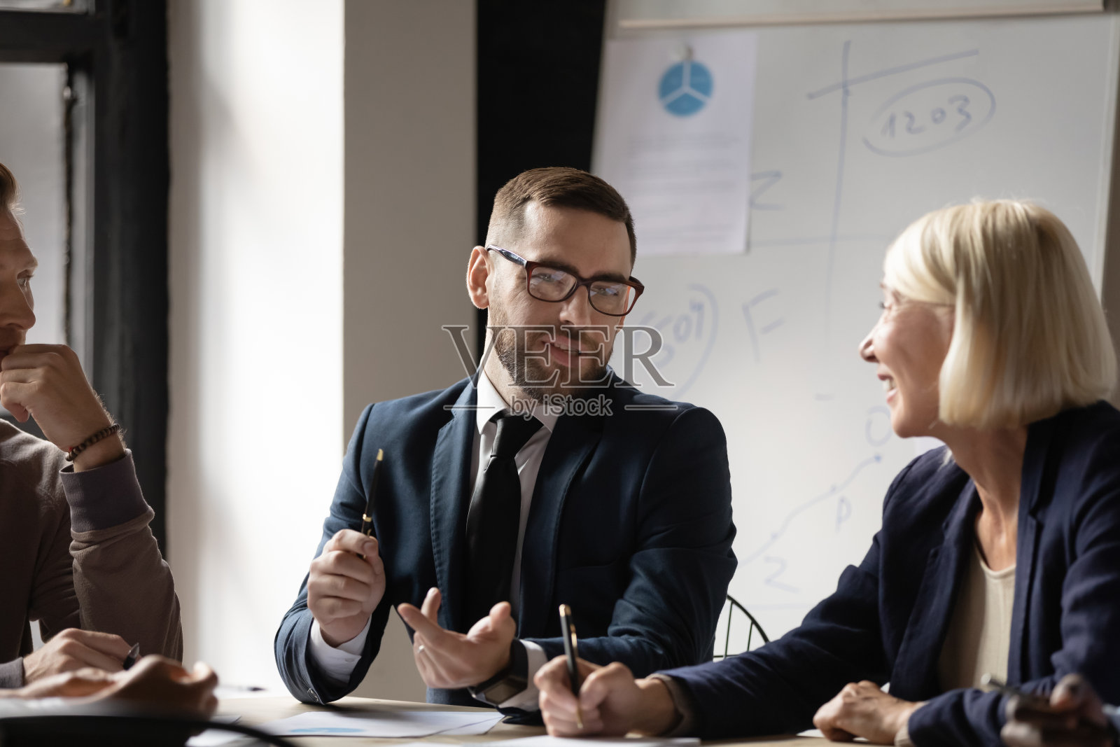 自信的商人在会议上与同事讨论项目策略照片摄影图片