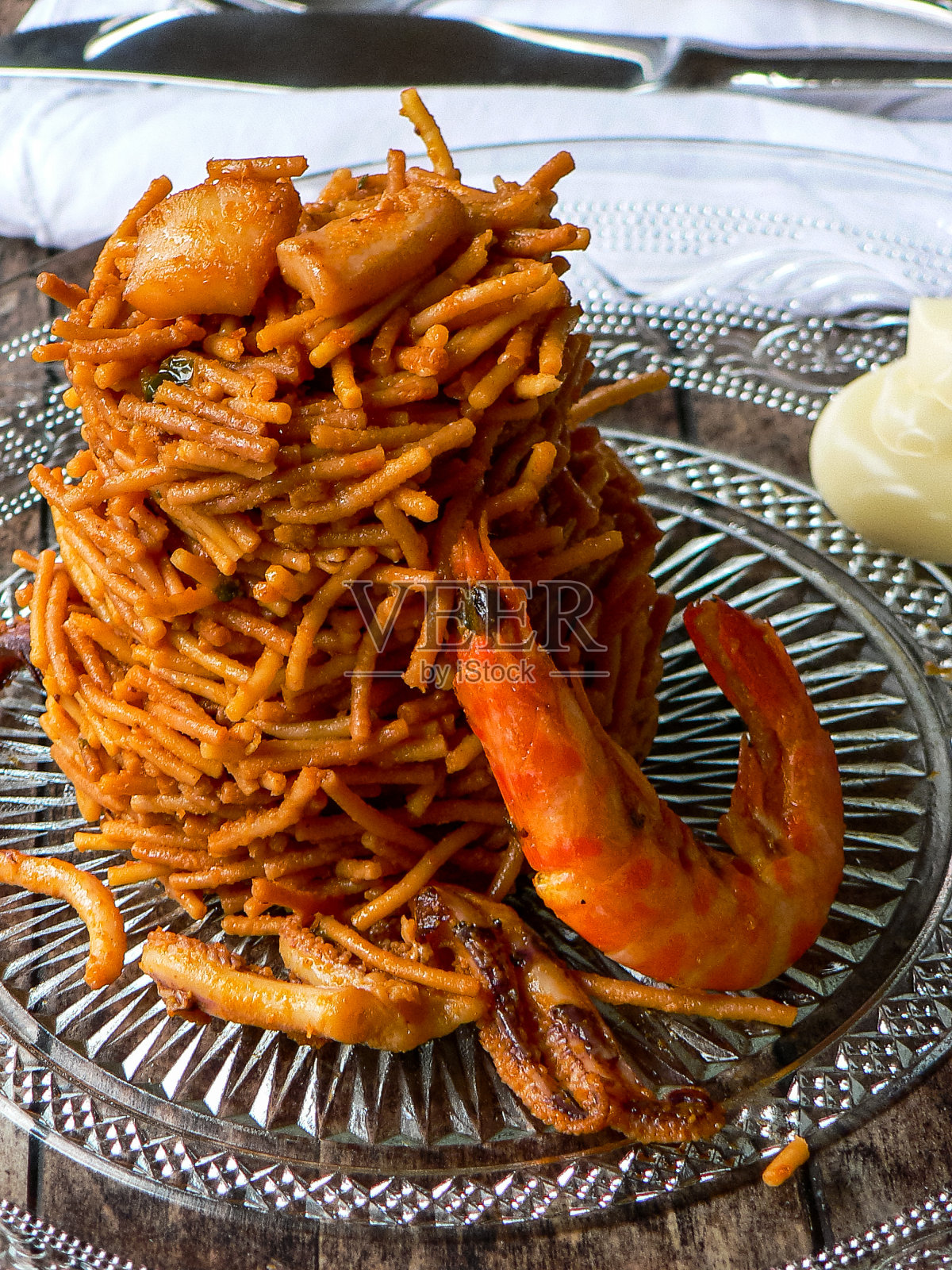 面条肉菜饭(fideua)。这是典型的加泰罗尼亚菜,由面条、海鲜、蒜酱和油制成照片摄影图片