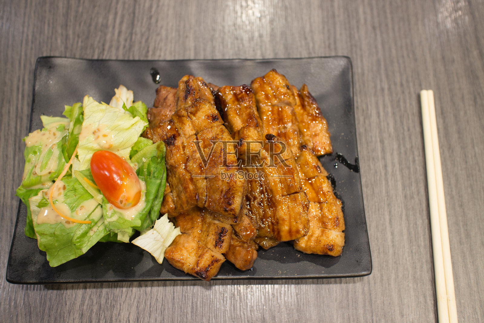 腹部烤猪肉日本风格称为北海道butta与蔬菜在黑色托盘和筷子在木头桌子上照片摄影图片