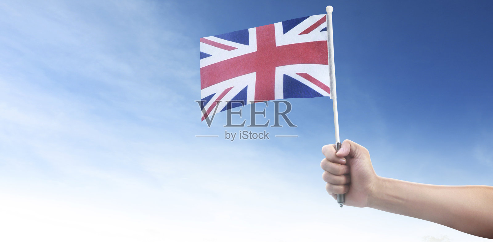 手举英语旗。手里拿着国旗照片摄影图片