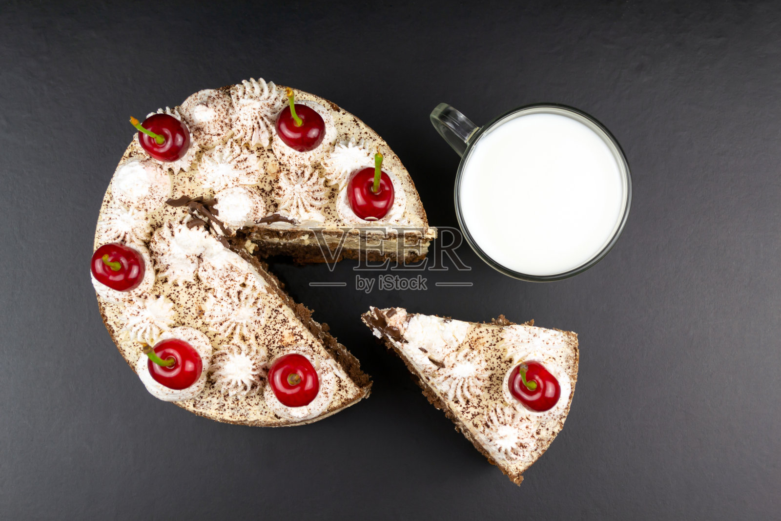 提拉米苏蛋糕装饰樱桃,切片蛋糕和一杯牛奶照片摄影图片