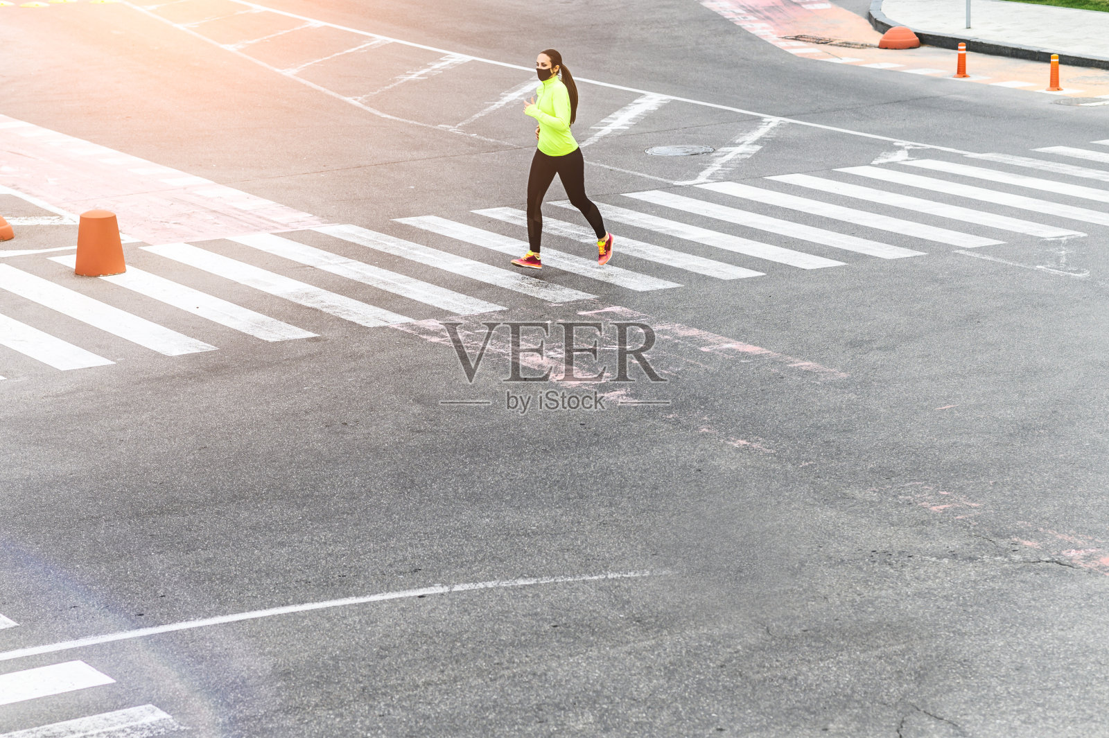 一个脸上戴着医用口罩的女人跑了照片摄影图片