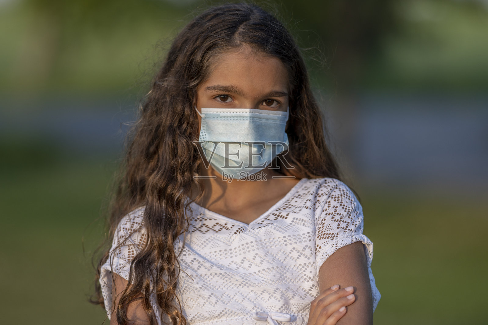 美丽的10岁女孩戴着一个保护面罩外面照片摄影图片