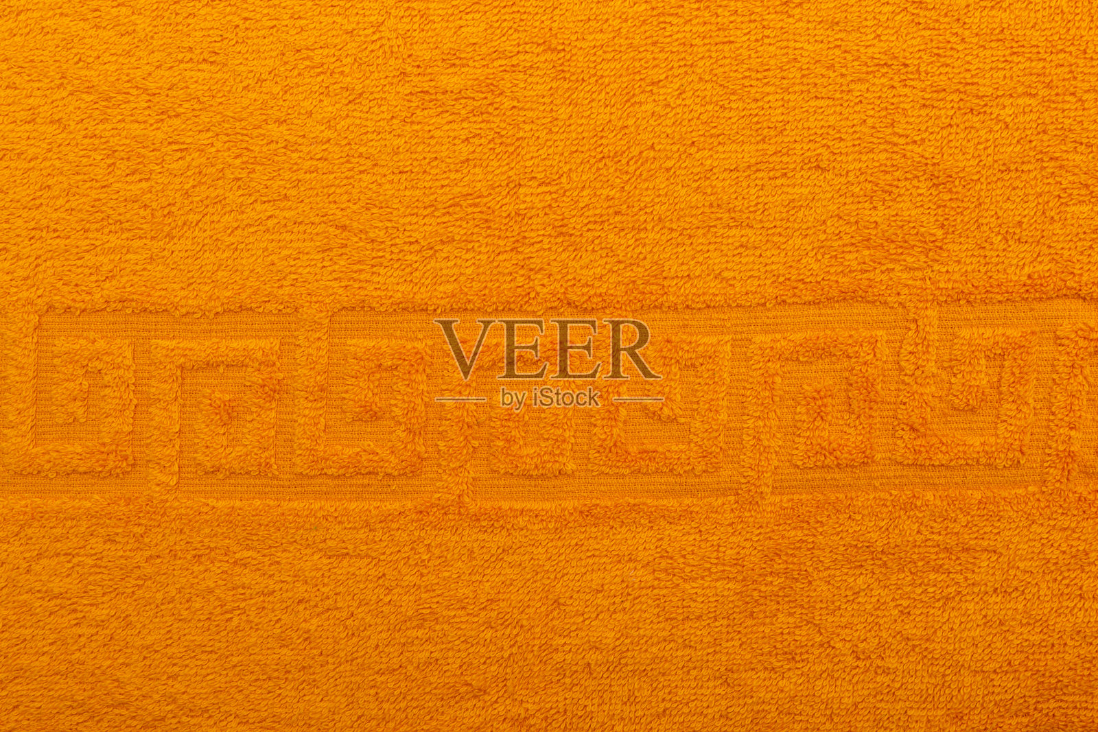 毛巾布,纹理,纺织背景接近。特里橙色毛巾背景。颜色橙色毛巾布制成的棉布。结构与未切断螺纹环。橙色背景的毛巾照片摄影图片