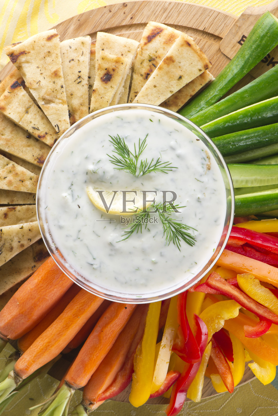 酸奶黄瓜或鹰嘴豆泥。经典的希腊或地中海酱或蘸酱。希腊酸奶,波斯黄瓜,新鲜莳萝,橄榄油,柠檬,盐和胡椒,和皮塔饼,甜椒和新鲜蔬菜一起食用。经典的希腊,意大利,美国餐厅的开胃菜。照片摄影图片