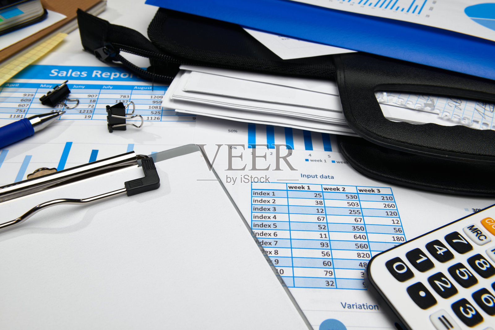 商务办公台面特写-财务报表、分析会计、套文件、图表、各种项目记帐、计算器照片摄影图片