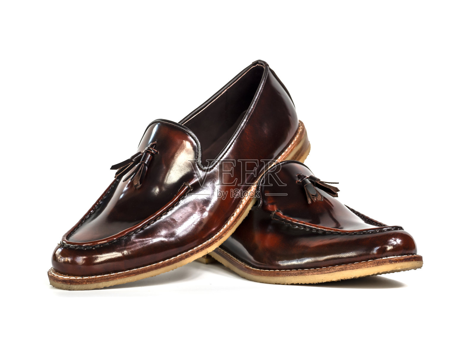 男士时尚流苏乐福鞋与棕色抛光皮革孤立在白色背景。照片摄影图片