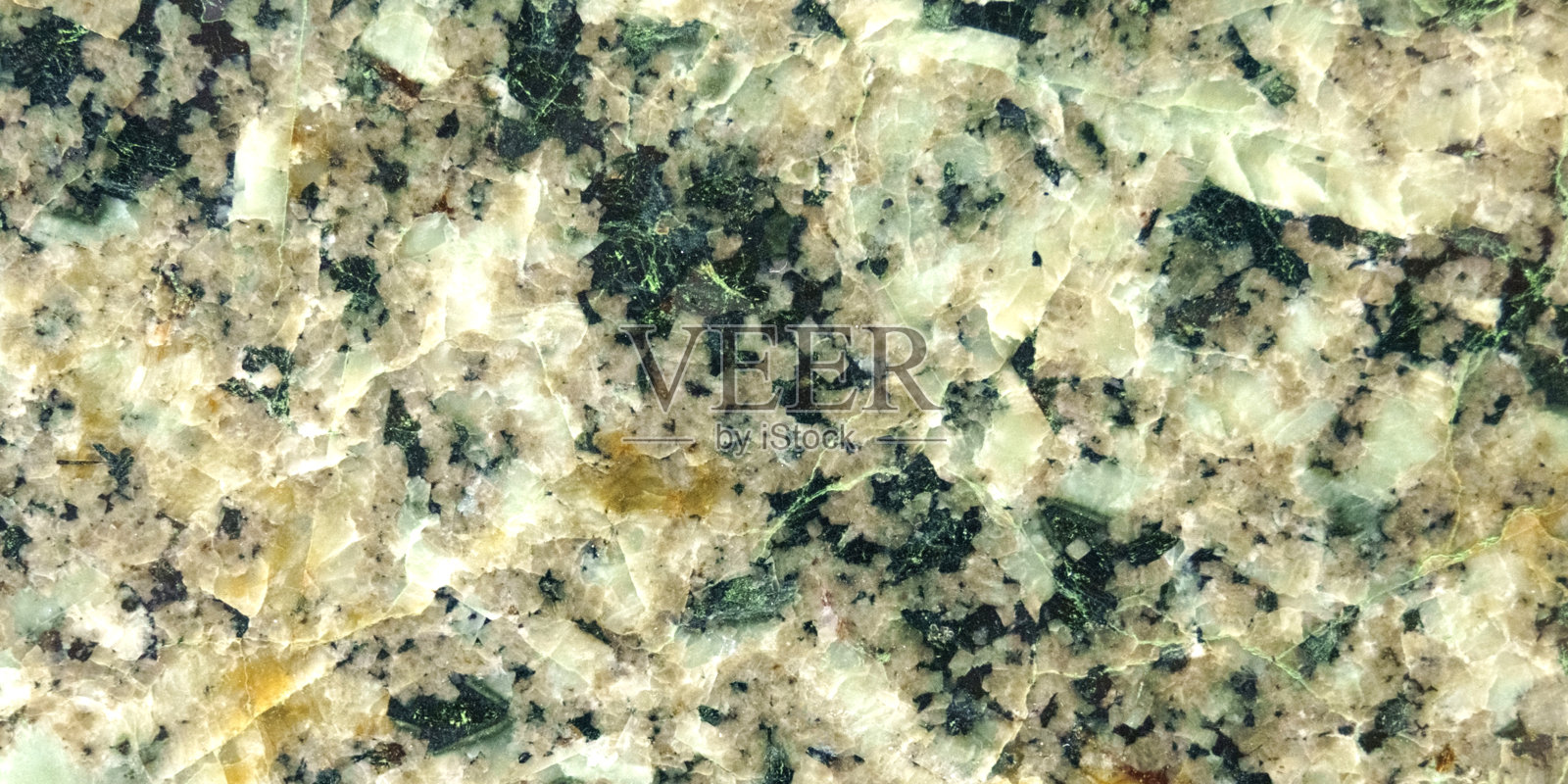 磨光的石头的纹理。绿色和米色表面。照片摄影图片