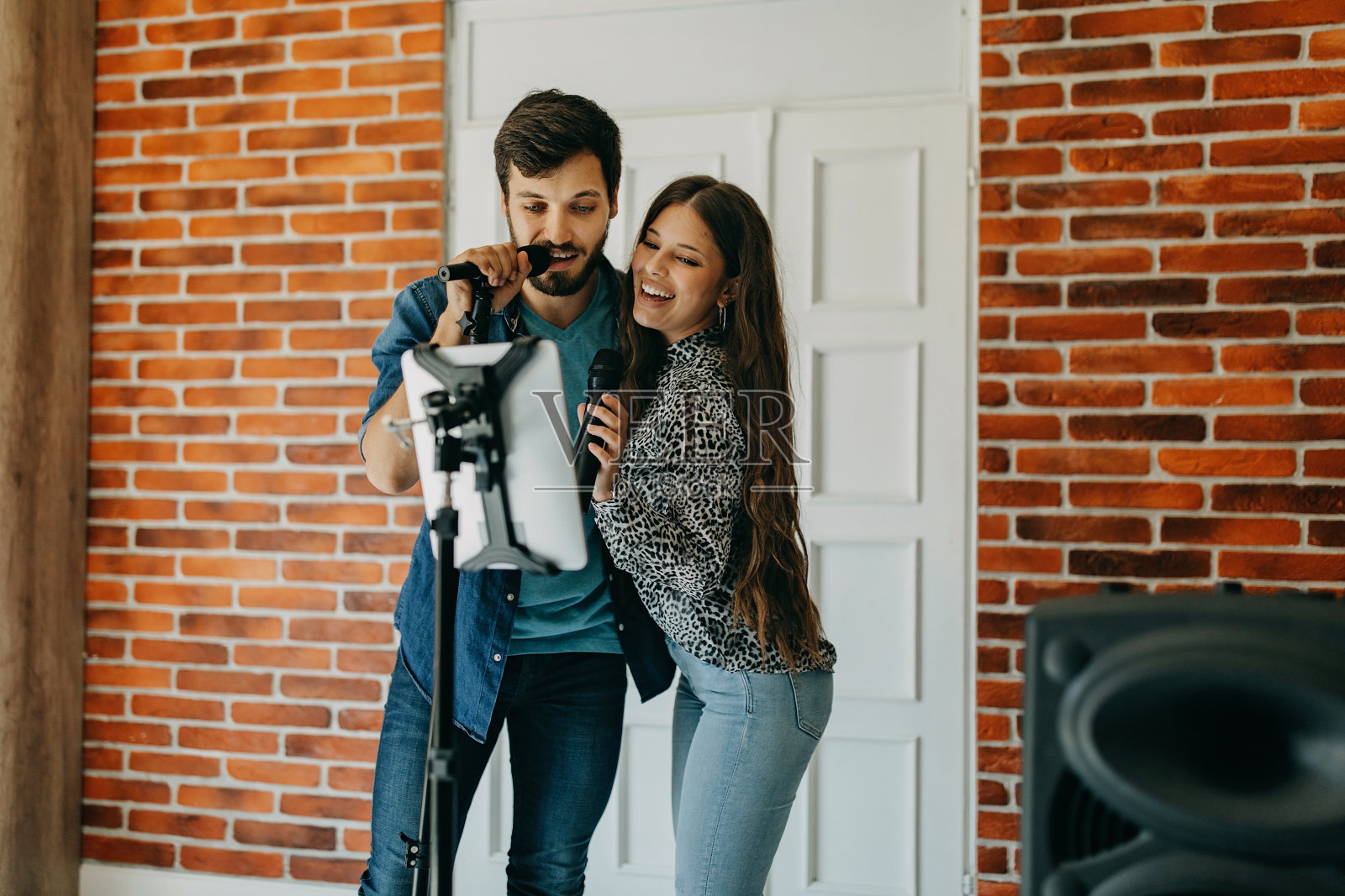 一对年轻夫妇在家卡拉ok派对上唱歌照片摄影图片