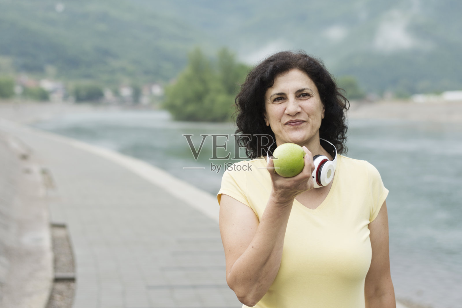 漂亮的运动女人吃苹果照片摄影图片
