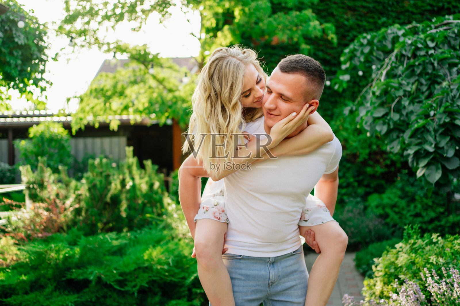 美丽和幸福的夫妇在花园里玩。照片摄影图片