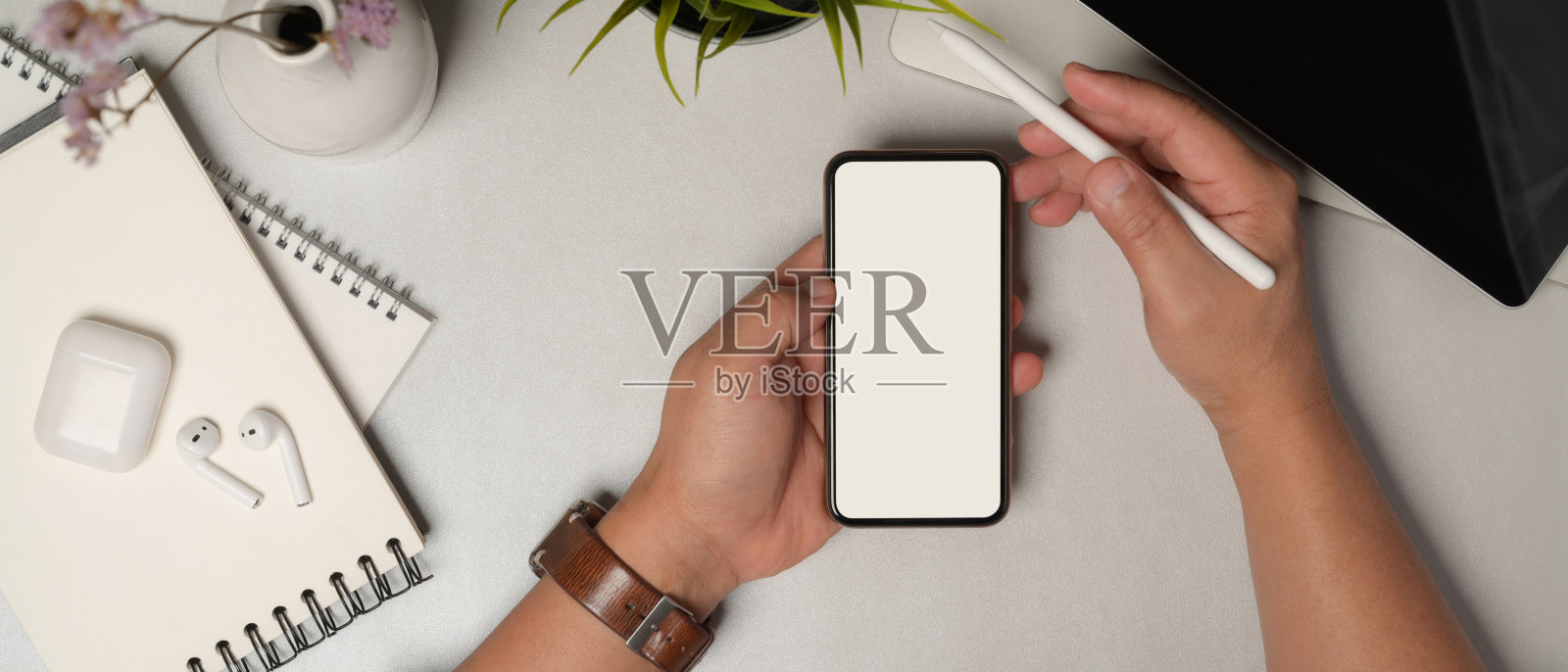 男性用智能手机在办公桌上移动照片摄影图片