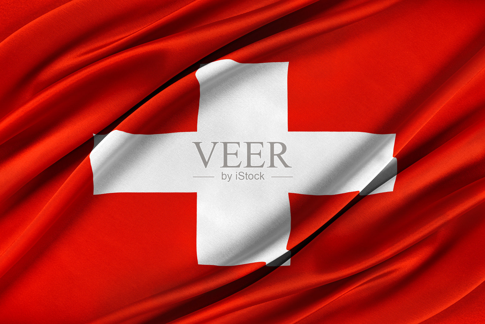 五颜六色的瑞士国旗迎风飘扬。照片摄影图片