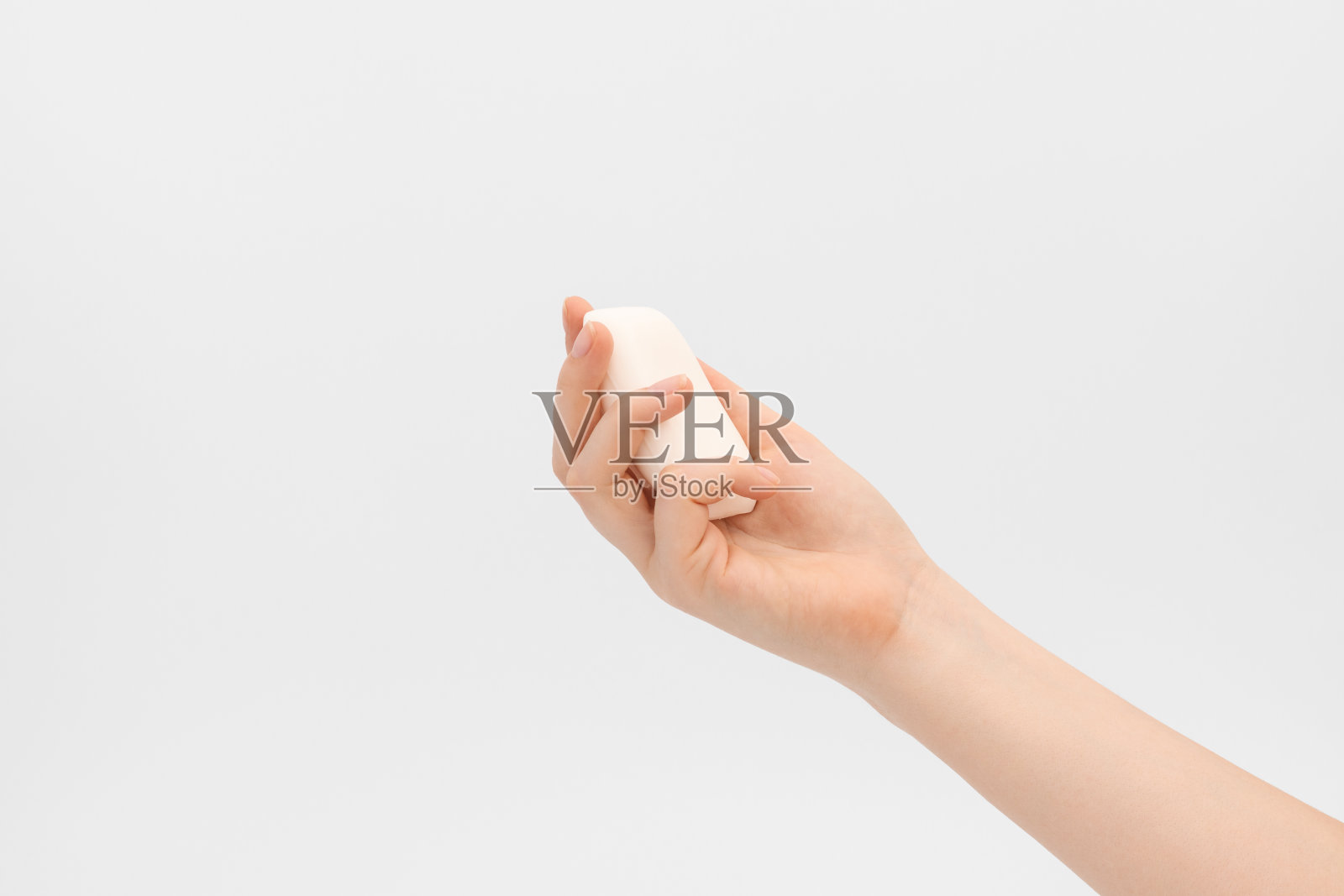 女人手里拿着一块肥皂。照片摄影图片