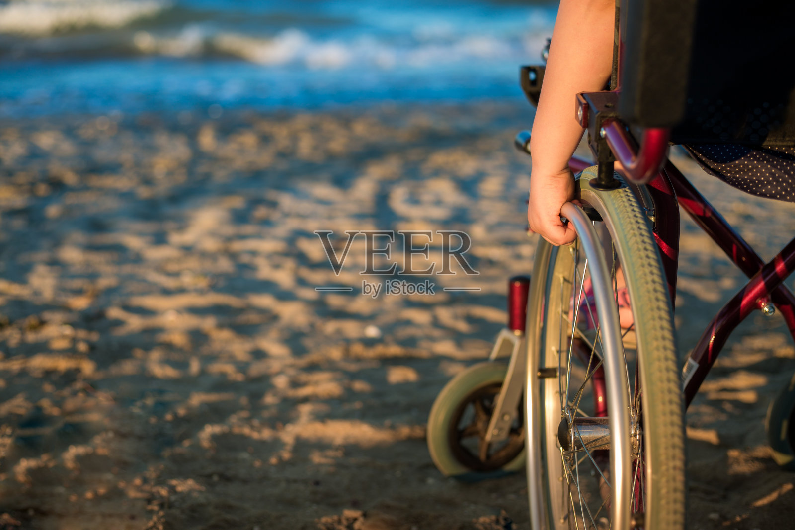 孩子的手控制着轮椅。照片摄影图片