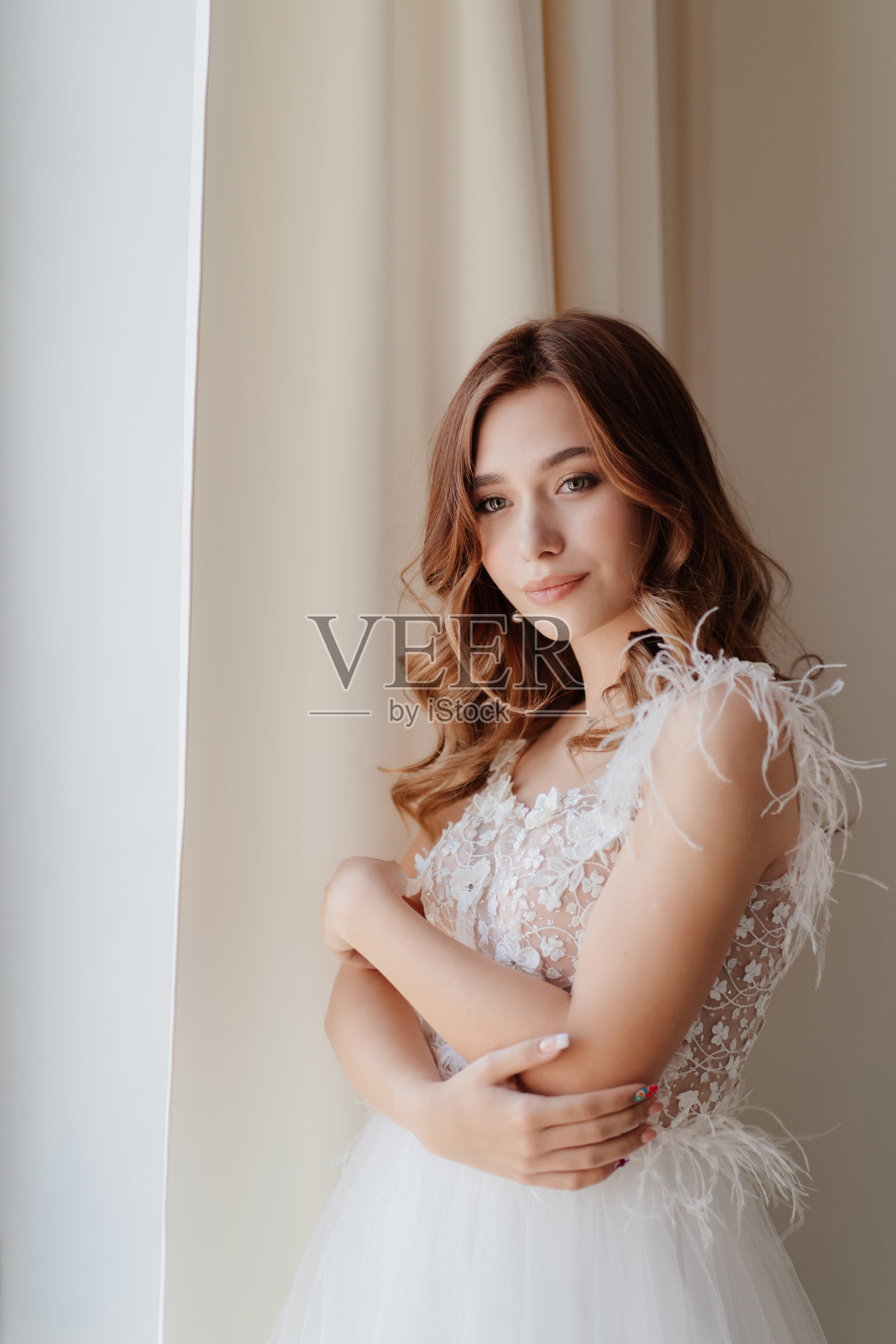 新娘穿着礼服,肩膀上裹着羽毛照片摄影图片