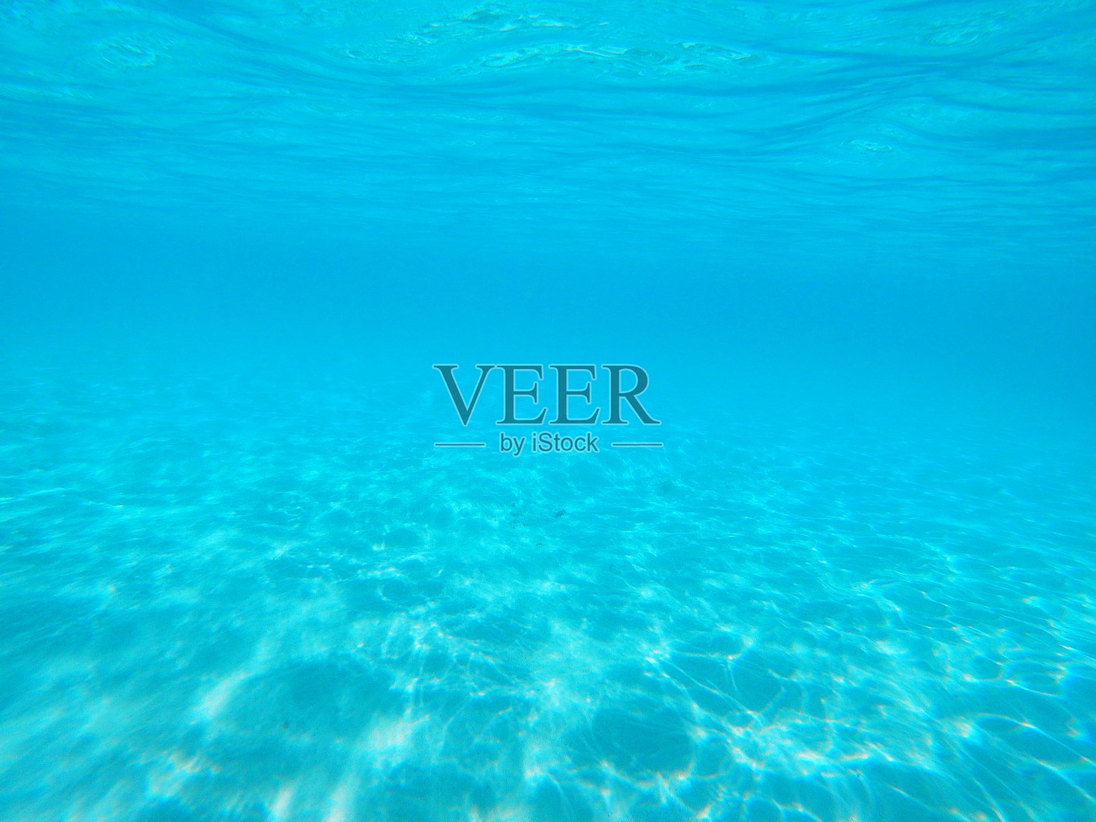 一个阳光斑驳的海底沙的水下图像照片摄影图片