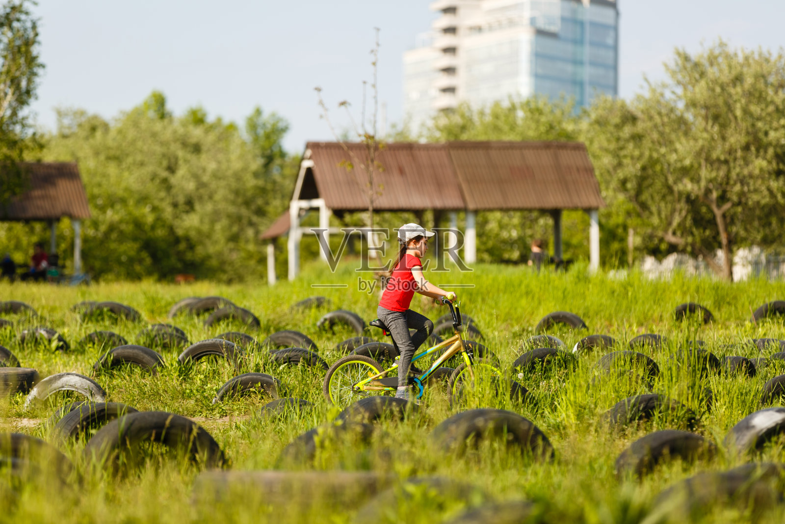 一个小女孩在夏天的公园户外骑自行车的肖像照片摄影图片