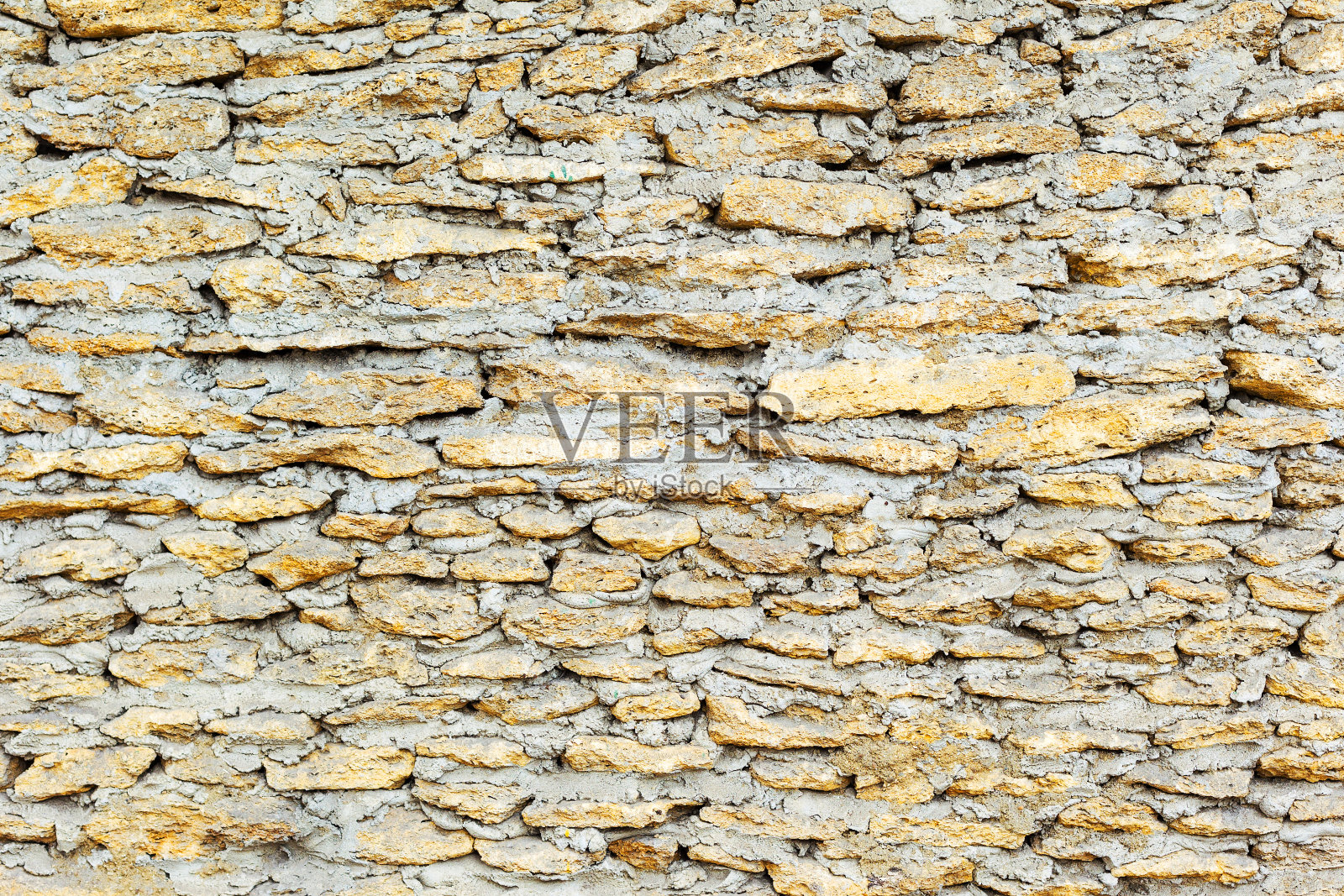 天然石材创意装饰墙。背景,石灰石墙体纹理,贝壳岩石块。很棒的背景或纹理。照片摄影图片