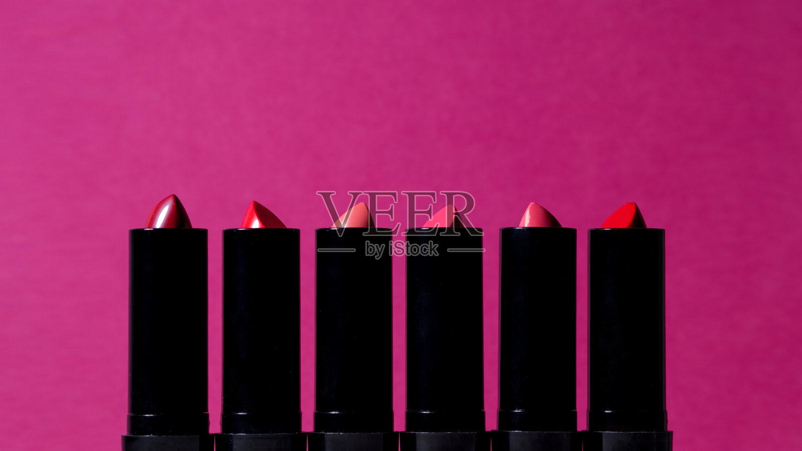 六种不同颜色的口红排成一排,照片摄影图片