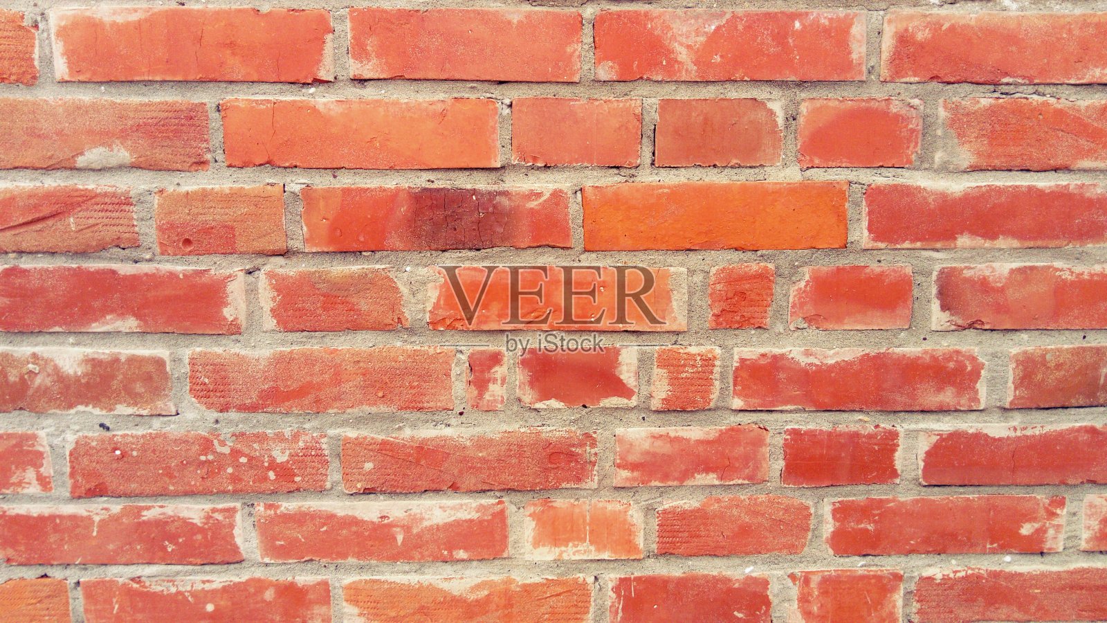 红砖砌成的砖墙。轻轻磨损表面。整齐的砖石,水泥在两排之间。枯燥乏味的背景。建筑物的外观。房间的内部。表面包覆。照片摄影图片