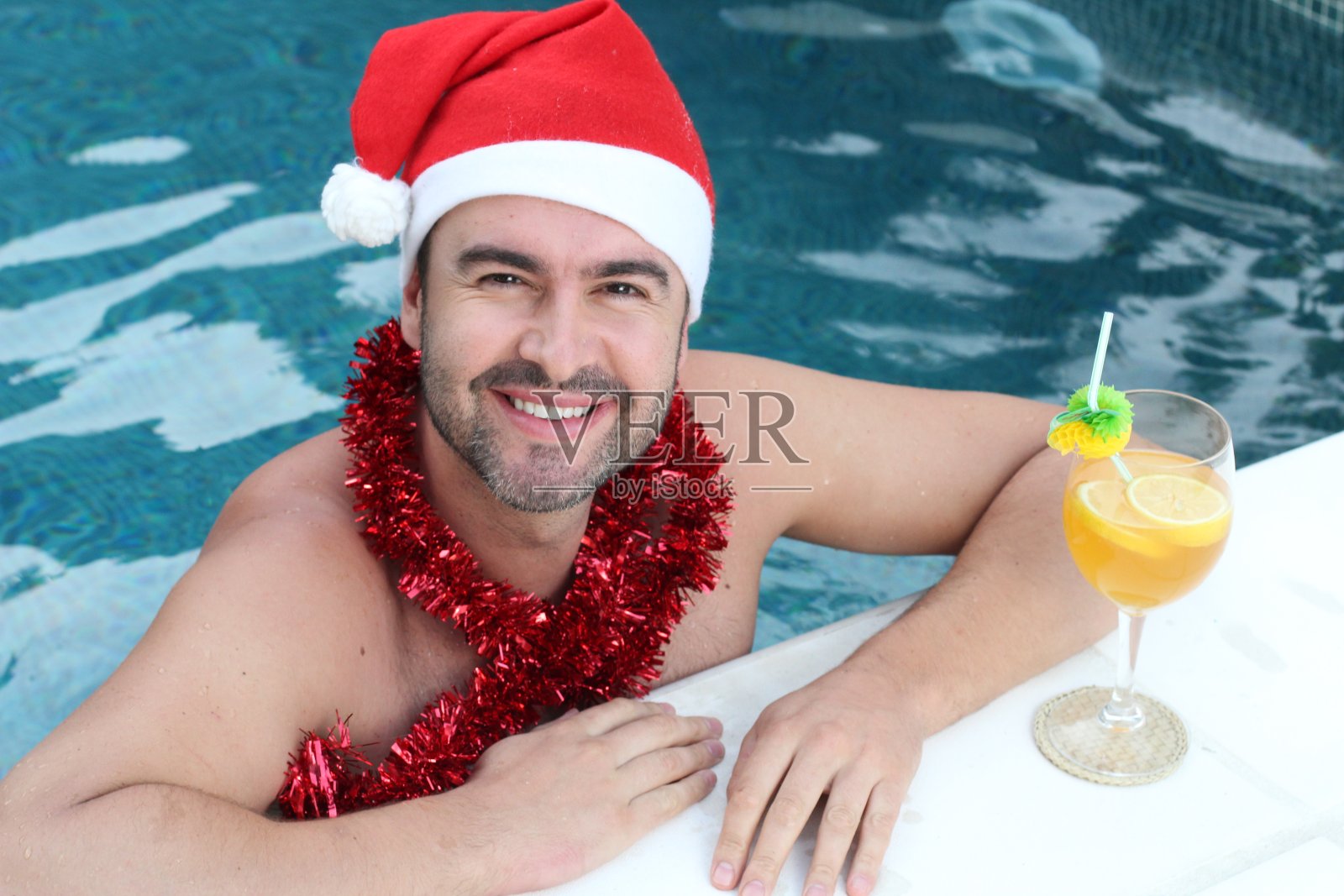 圣诞节期间游泳池里的男人照片摄影图片