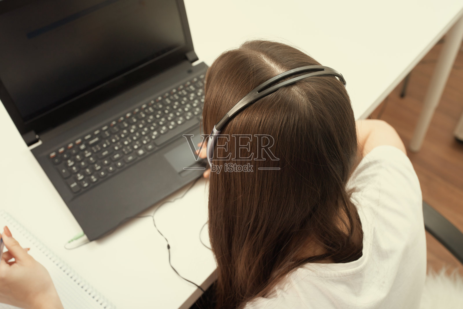 呼叫中心员工。这个女孩带着麦克风和耳机在办公室工作照片摄影图片