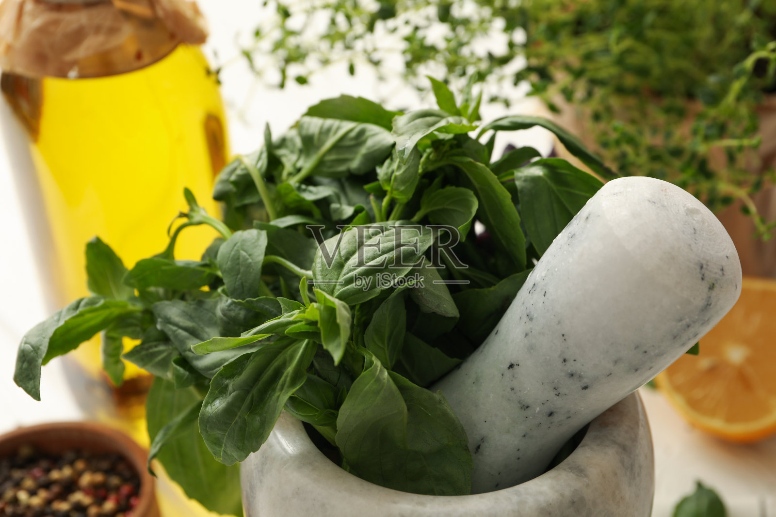不同的药草,油和香料在白色木质背景,特写照片摄影图片