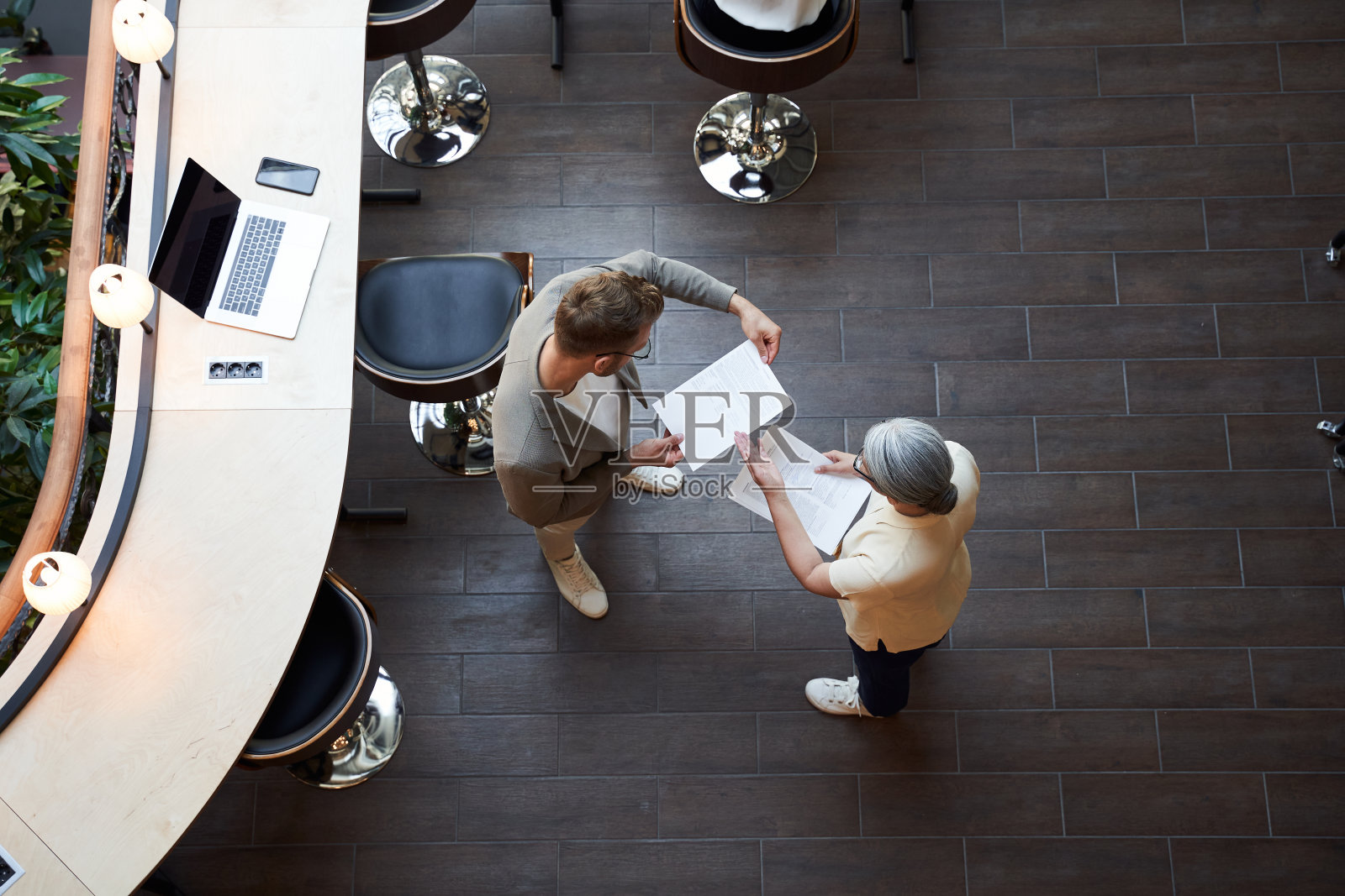 帅气的学生和他的教授在看论文照片摄影图片