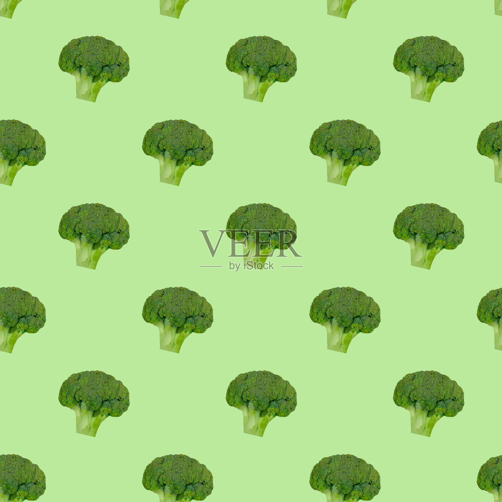 在绿色背景上的花椰菜卷心菜图案。健康饮食。素食主义。照片摄影图片