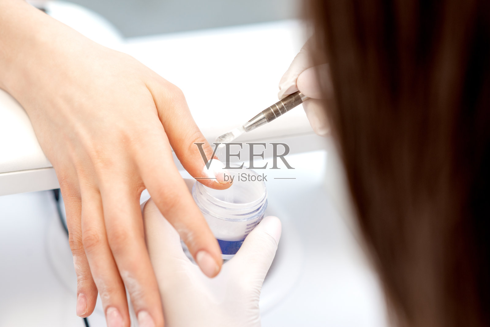 把丙烯酸粉涂在指甲上的过程照片摄影图片