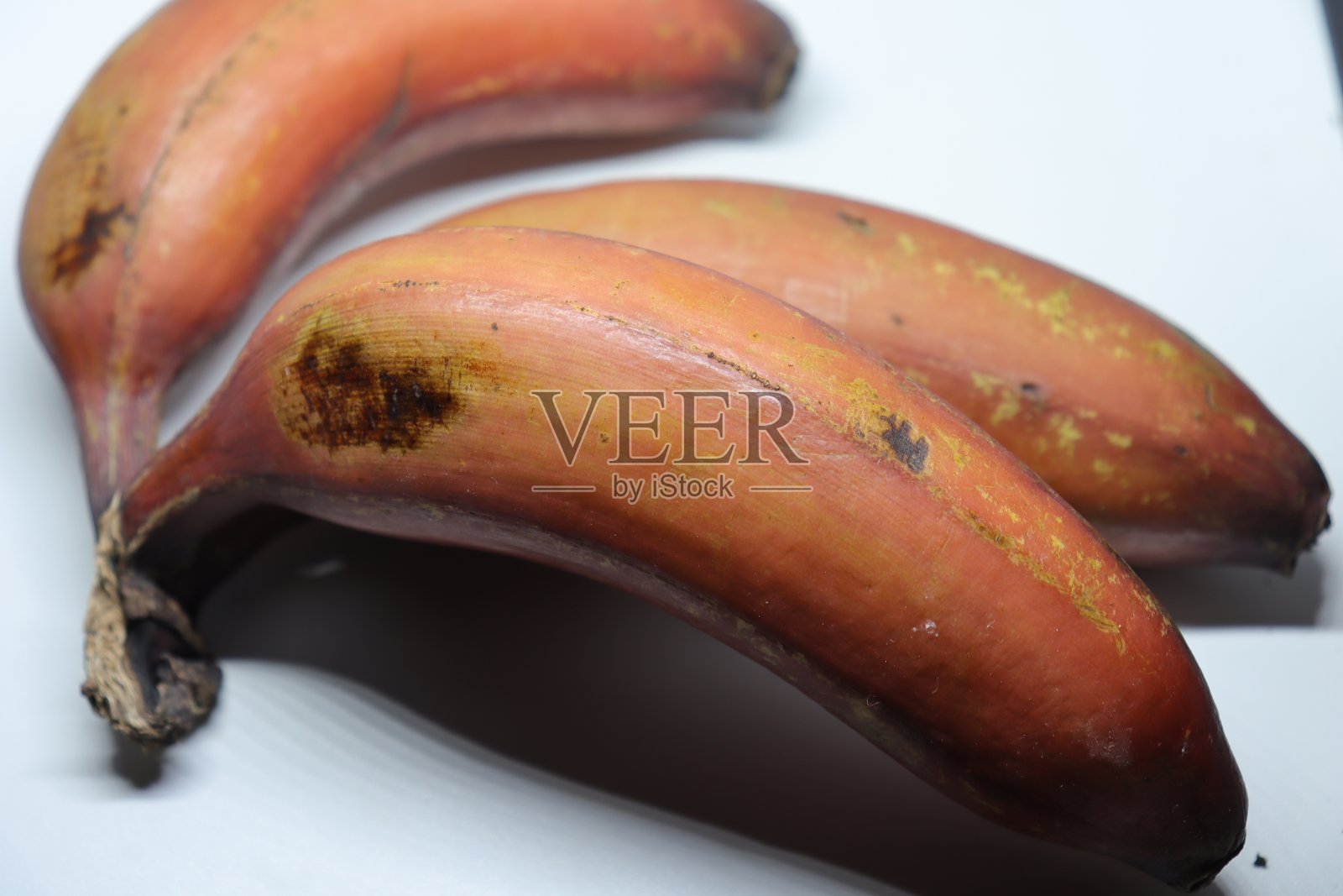 一束新鲜成熟的红色香蕉在白色的背景照片摄影图片