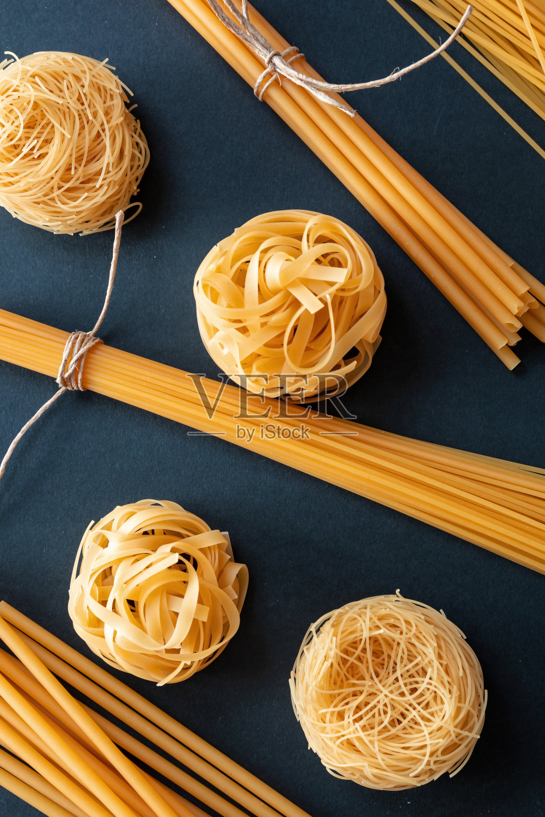 黑色背景上的意大利面,俯视图。烹饪意大利菜的概念照片摄影图片