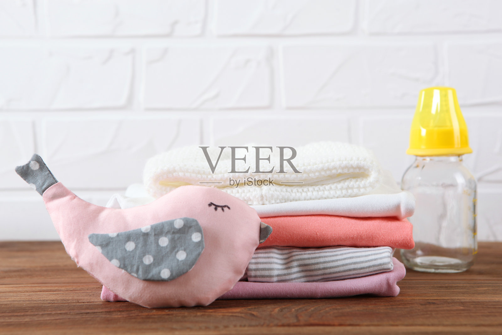 浅色背景上的一叠婴儿衣服。照片摄影图片