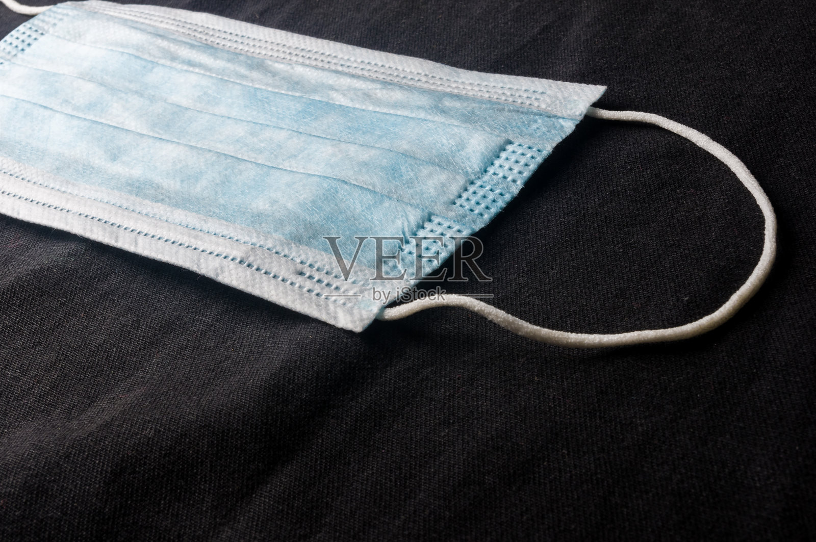 新型冠状病毒(COVID-19)大流行新闻的背景概念,用于预防冠状病毒的抗病毒医疗口罩。手术防护面具。医用呼吸包扎面部,拷贝空间刻字。照片摄影图片