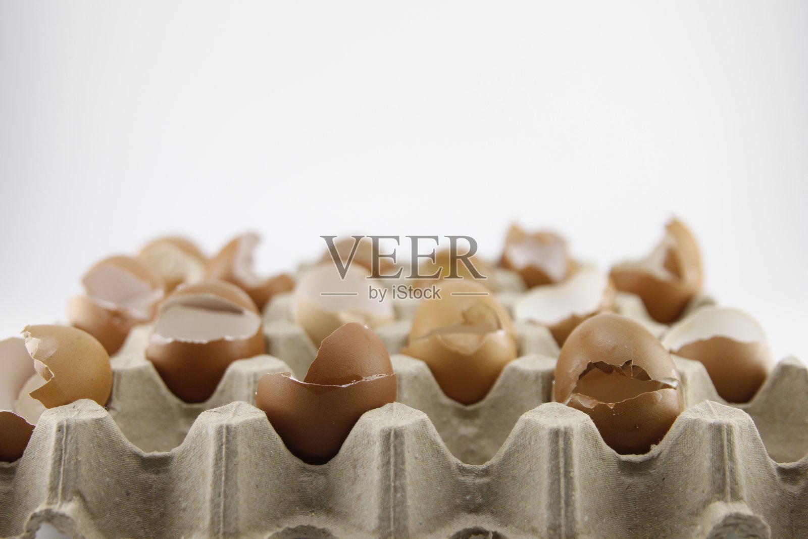 鸡蛋壳被放在一个装鸡蛋的纸盒里。照片摄影图片