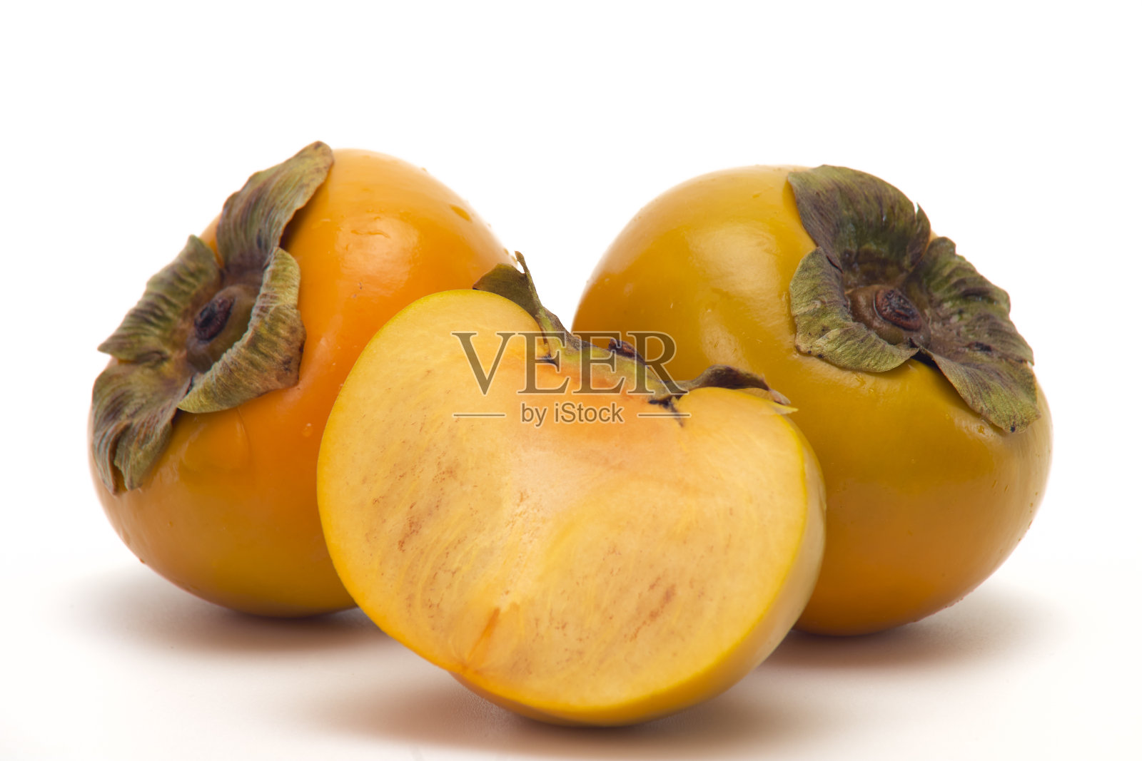 白色背景下的新鲜柿子照片摄影图片