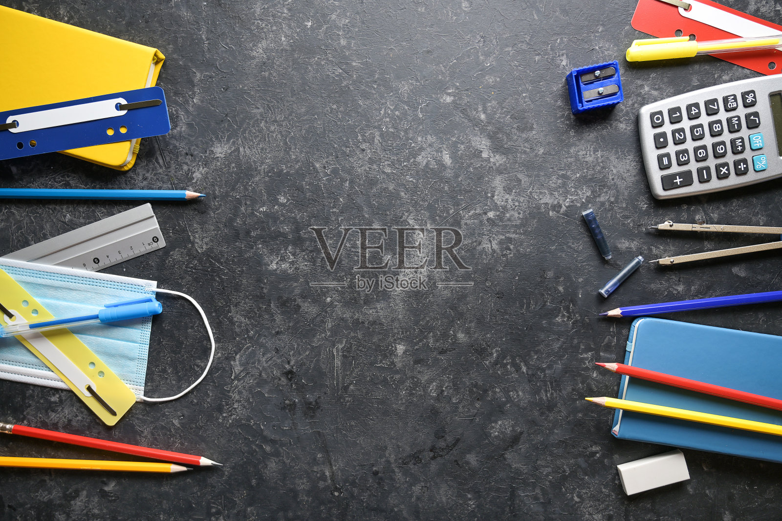 文具学校用品和防冠状病毒和covid - 19感染的外科口罩,框架两侧有黑色背景,返回学校和新常态概念,拷贝空间,高角度从上方观看照片摄影图片