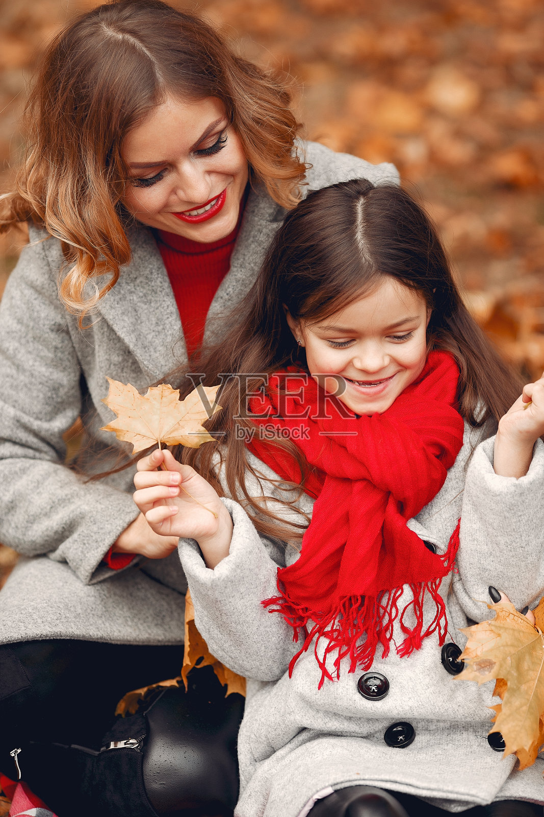 可爱和时尚的家庭在秋天的公园照片摄影图片