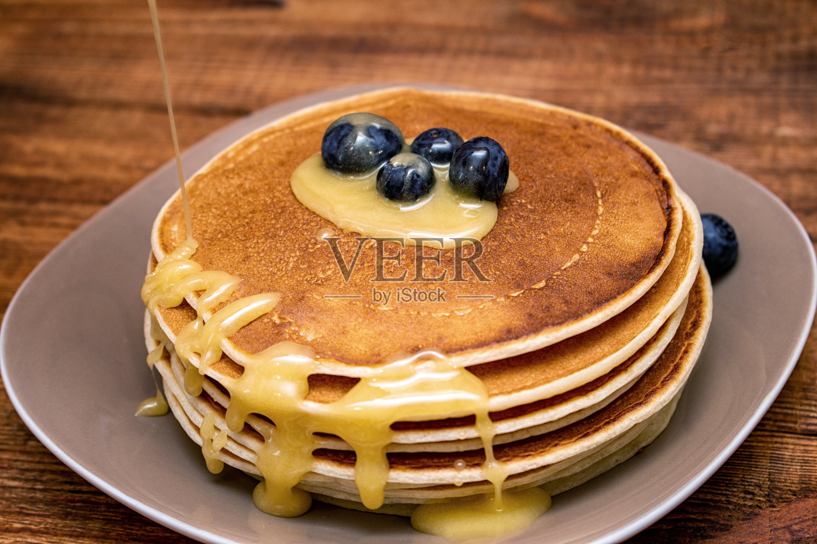 棕色木制背景上的煎饼照片摄影图片